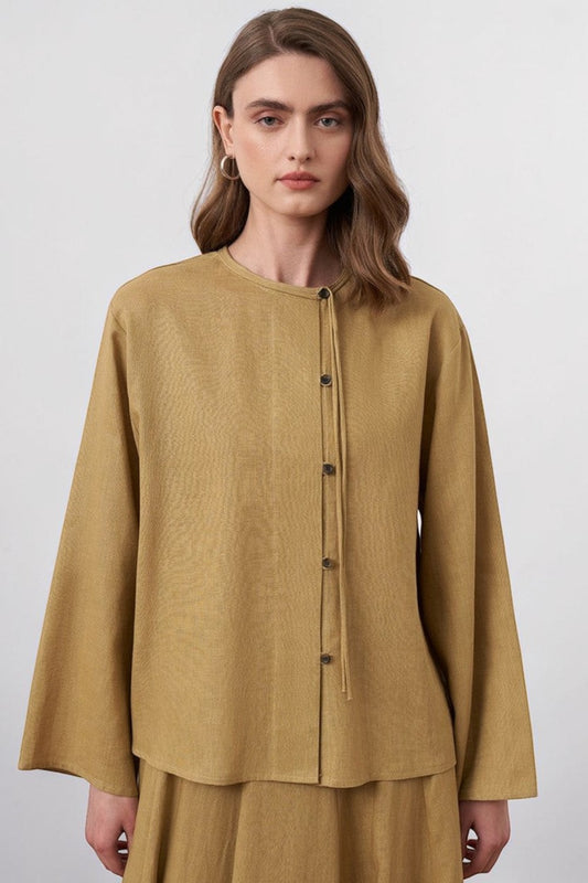 Cherianne.com mustard linen blend shirt with mandarin collar, asymmetric button placket, and drop shoulders on model
