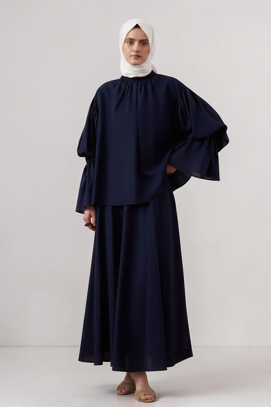 Cherianne.com navy blue linen blend blouse with gathered high neck and voluminous balloon sleeves on a model