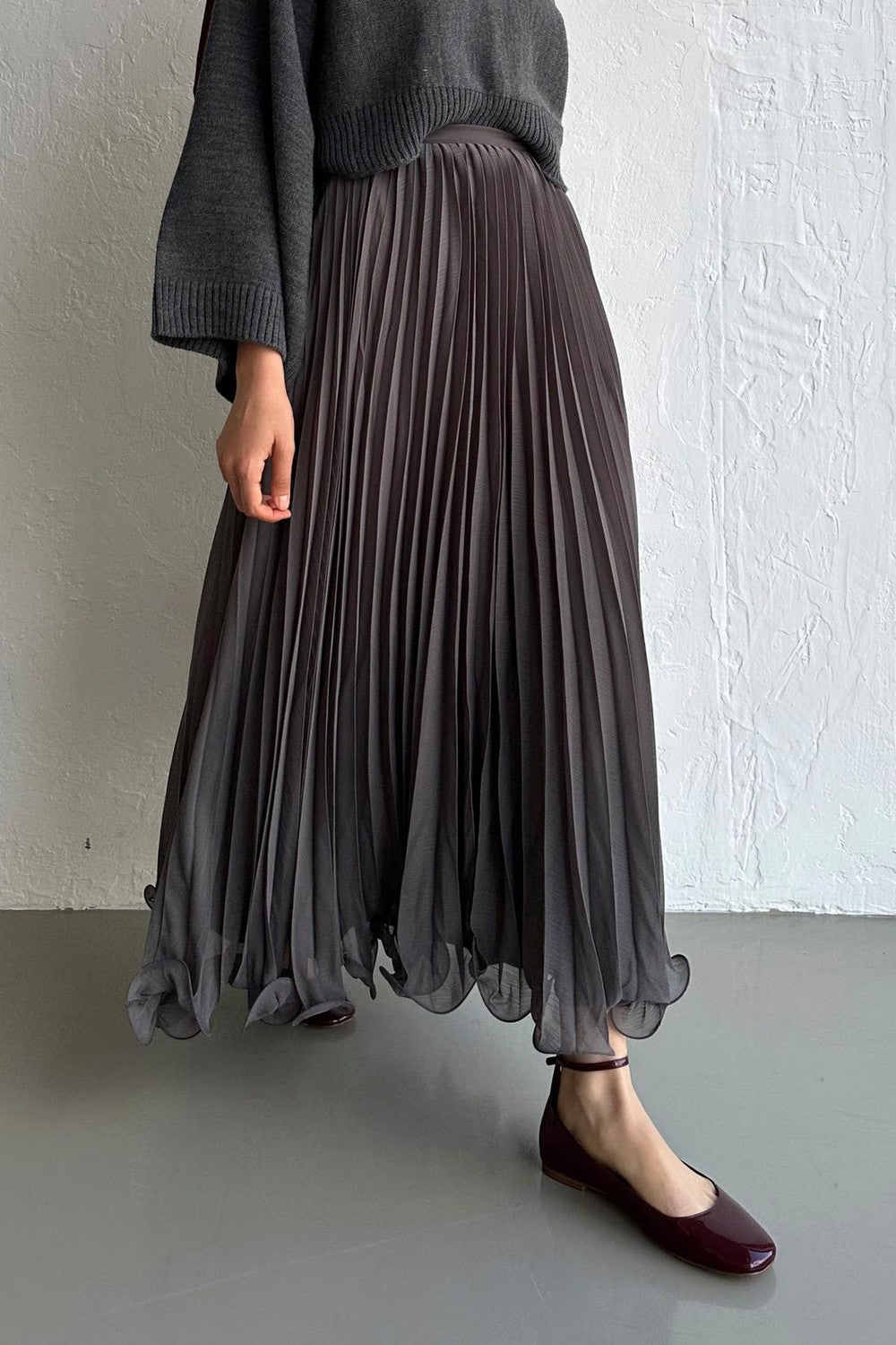 Cherianne.com gray pleated chiffon maxi skirt paired with a dark gray sweater, featuring a flowy silhouette.