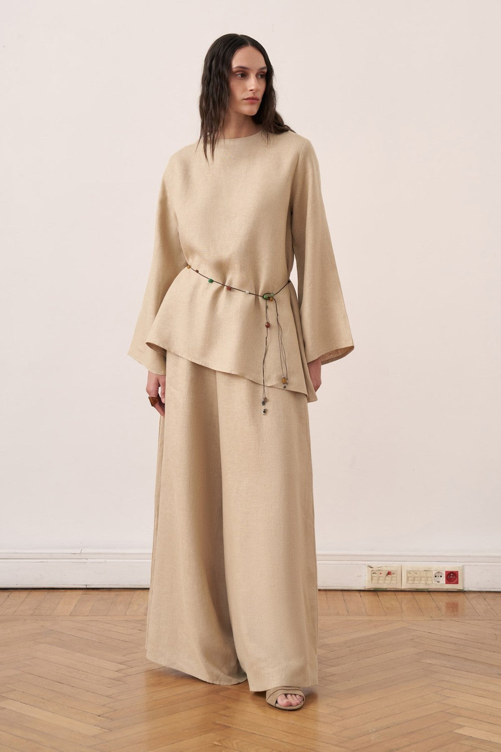 Cherianne.com wheat beige linen blouse with wide Spanish sleeves and asymmetrical hem worn with matching linen pants