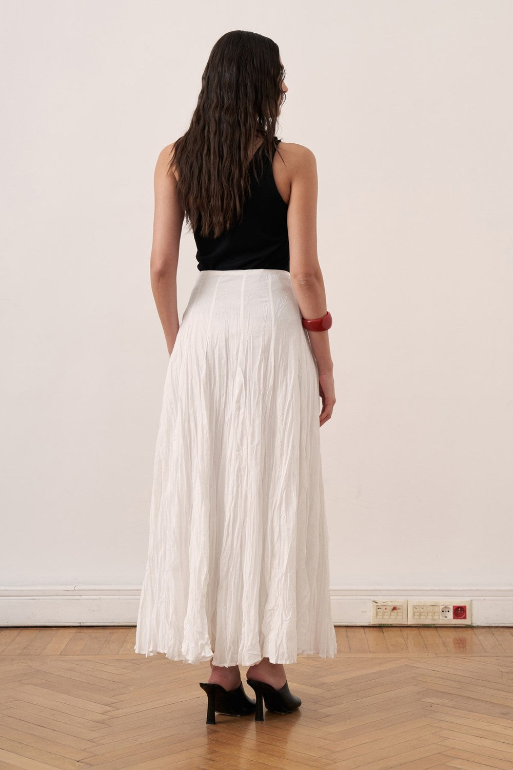 Cherianne.com white cotton voile maxi skirt with a crinkled texture and high-waisted paneled design on a model