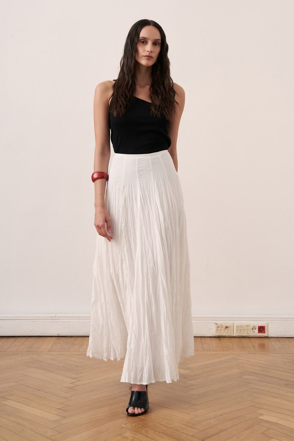 Cherianne.com white cotton voile maxi skirt with a crinkled texture and high-waisted paneled design on a model