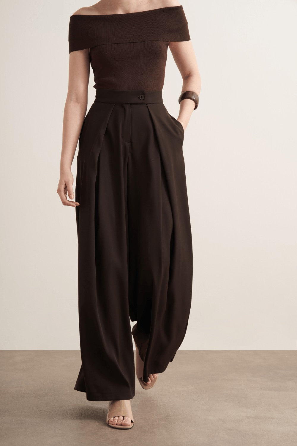 Cherianne.com Leona high-waisted wide-leg trousers in dark brown polyester with a ruffled design and side pockets.