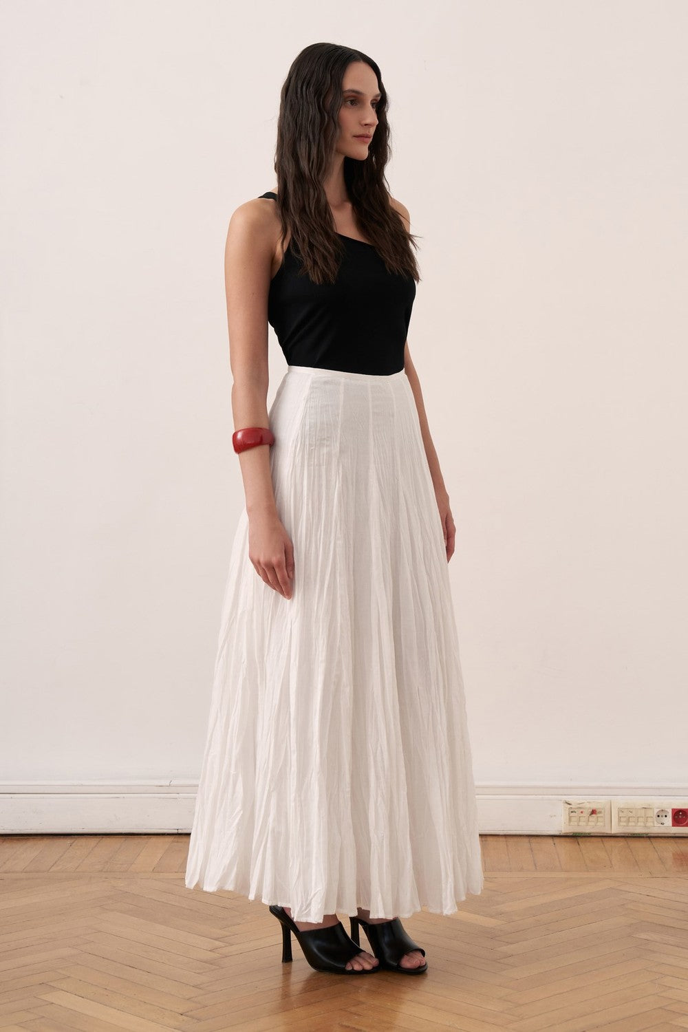 Cherianne.com white cotton voile maxi skirt with a crinkled texture and high-waisted paneled design on a model