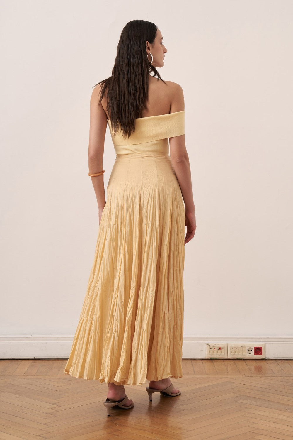 Cherianne.com yellow cotton voile maxi skirt with a crinkled texture and high-waisted paneled design on a model.