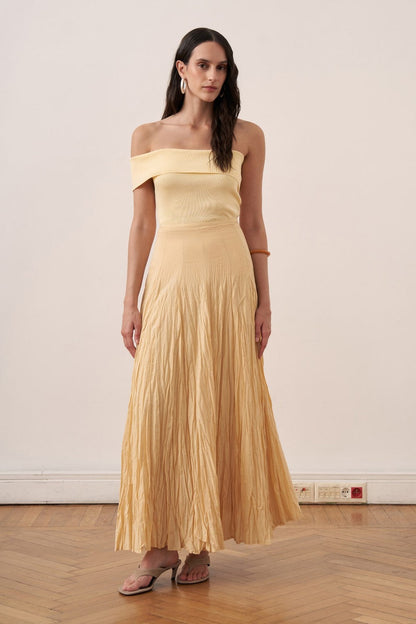 Cherianne.com yellow cotton voile maxi skirt with a crinkled texture and high-waisted paneled design on a model.