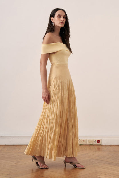 Cherianne.com yellow cotton voile maxi skirt with a crinkled texture and high-waisted paneled design on a model.