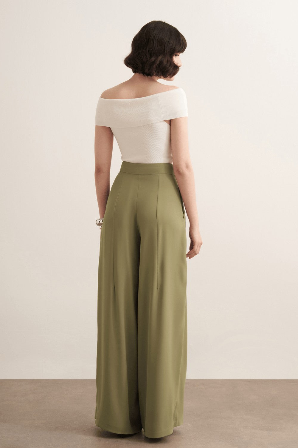 Cherianne.com Leona high-waisted wide-leg olive green trousers with pleated detail worn by a model