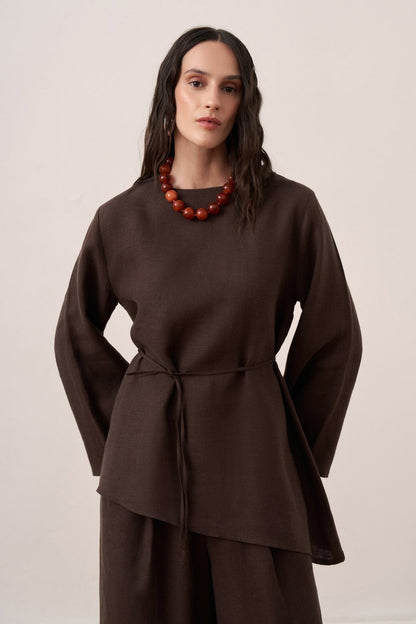 Cherianne.com dark brown linen blouse with wide sleeves, crew neck, and adjustable waist tie on a model.