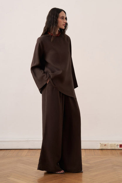Cherianne.com dark brown linen blouse with wide sleeves, crew neck, and adjustable waist tie on a model.