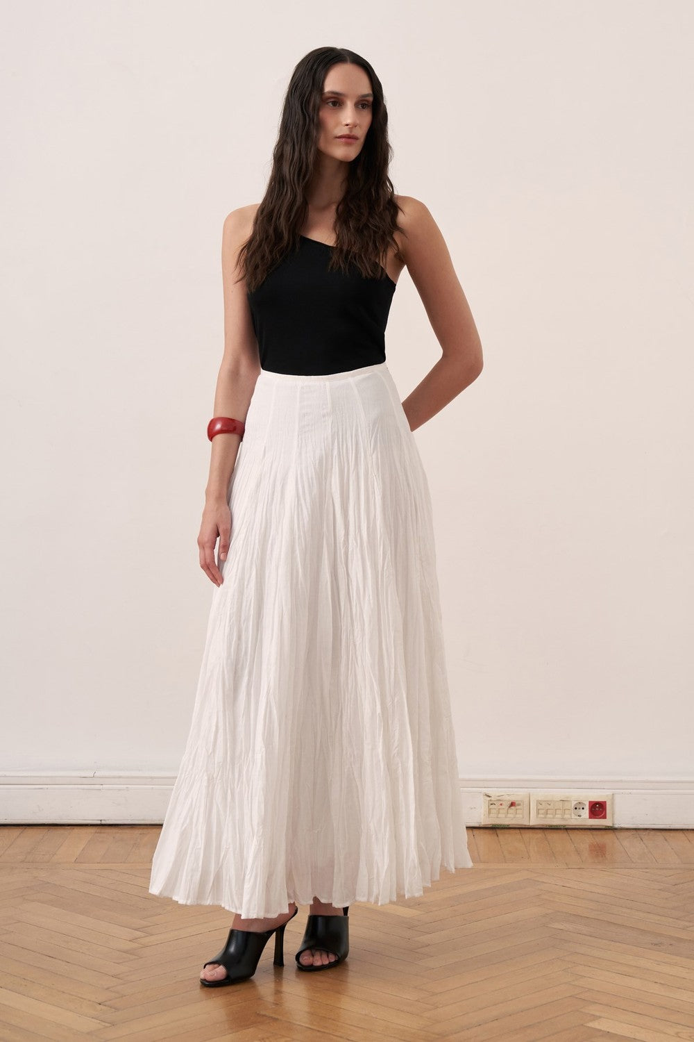 Cherianne.com white cotton voile maxi skirt with a crinkled texture and high-waisted paneled design on a model