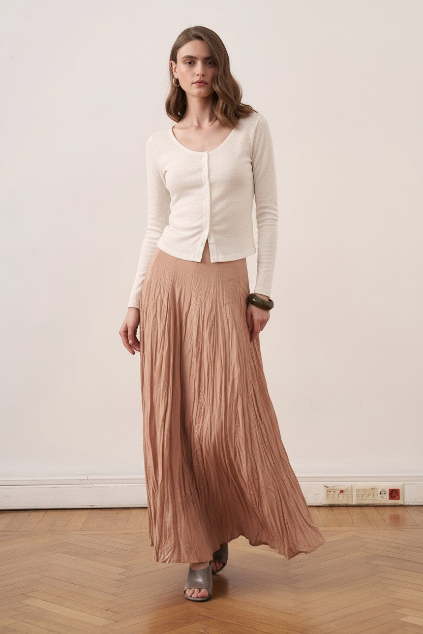 Cherianne.com beige cotton voile maxi skirt with a crinkled texture, worn by a model with a white button-up top.