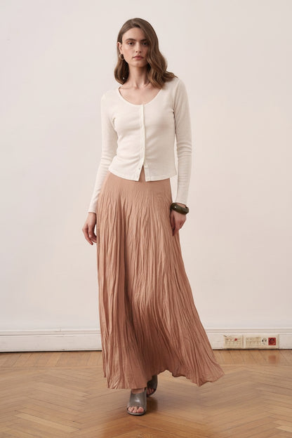 Cherianne.com beige cotton voile maxi skirt with a crinkled texture, worn by a model with a white button-up top.