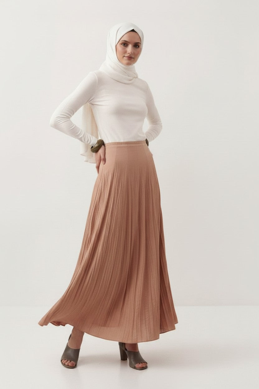 Model wearing a Cherianne.com beige cotton voile maxi skirt with a crushed texture and high-waisted panel design.
