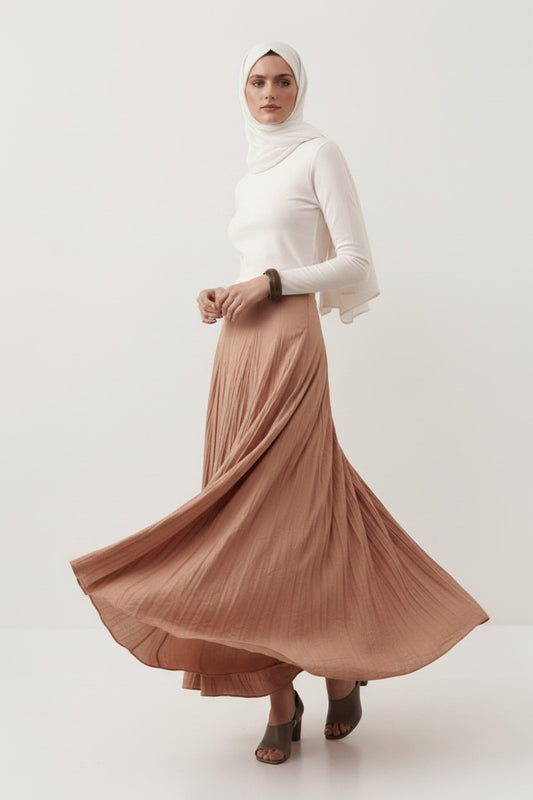 Cherianne.com model wearing a beige cotton voile maxi skirt with a crushed texture and a white long-sleeve top.