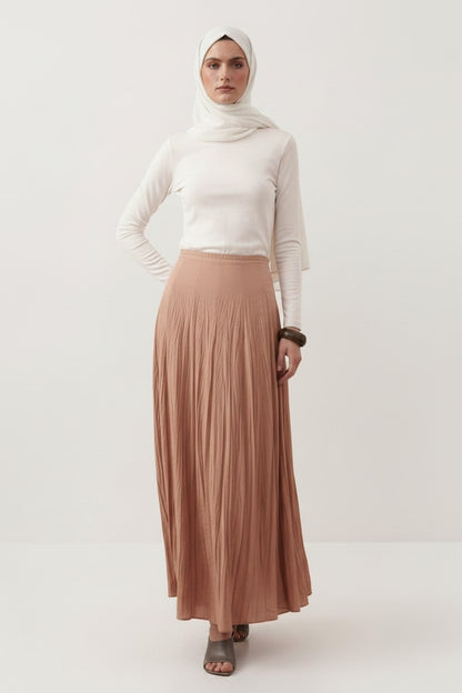 Cherianne.com beige cotton voile maxi skirt with a crushed texture and high-waisted paneled design on a model.