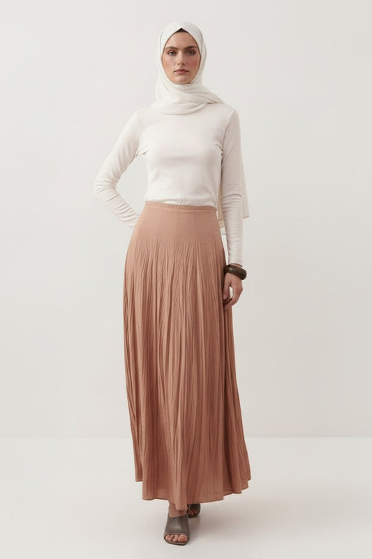 Cherianne.com beige cotton voile maxi skirt with a crushed texture and high-waisted paneled design on a model.