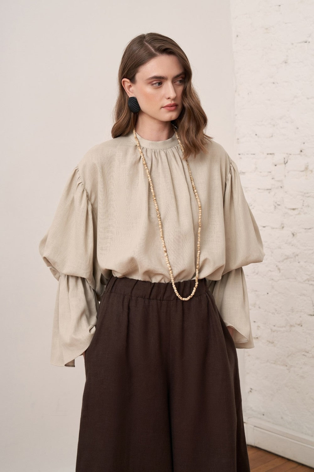 Cherianne.com beige linen blend blouse with voluminous balloon sleeves and gathered cuffs worn by a model