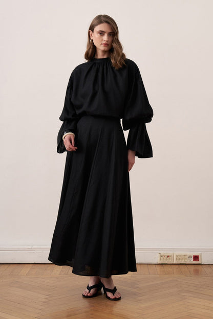 Cherianne.com black linen blend blouse with voluminous balloon sleeves and a minimalist gathered mock neck collar.