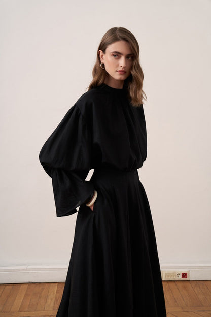 Cherianne.com black linen blend blouse with voluminous balloon sleeves and a minimalist gathered mock neck collar.