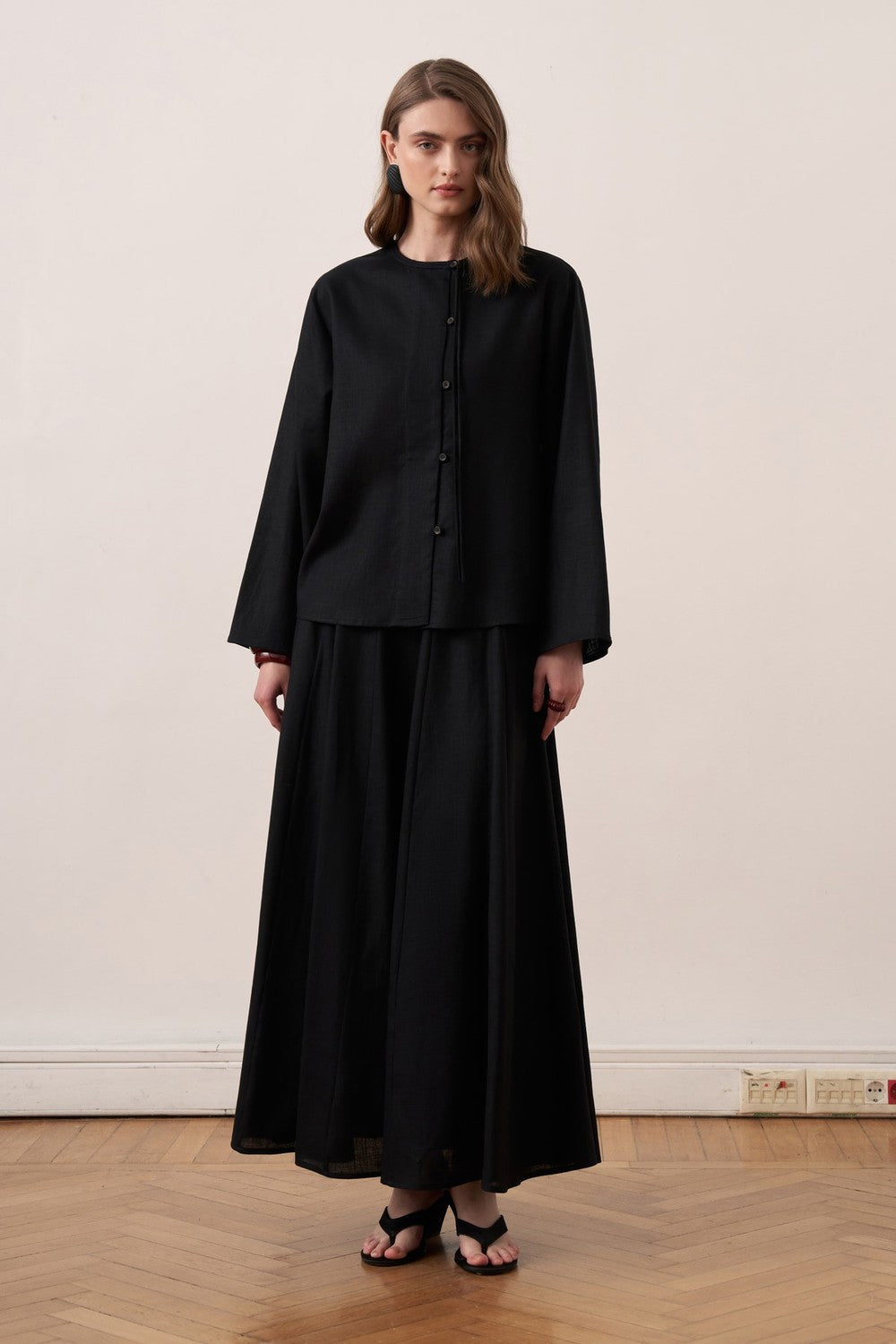 Cherianne.com black linen blend shirt with mandarin collar, asymmetric button placket, and relaxed drop shoulder fit.