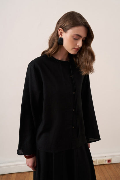 Cherianne.com black linen blend shirt with mandarin collar, asymmetric button placket, and relaxed drop shoulder fit.
