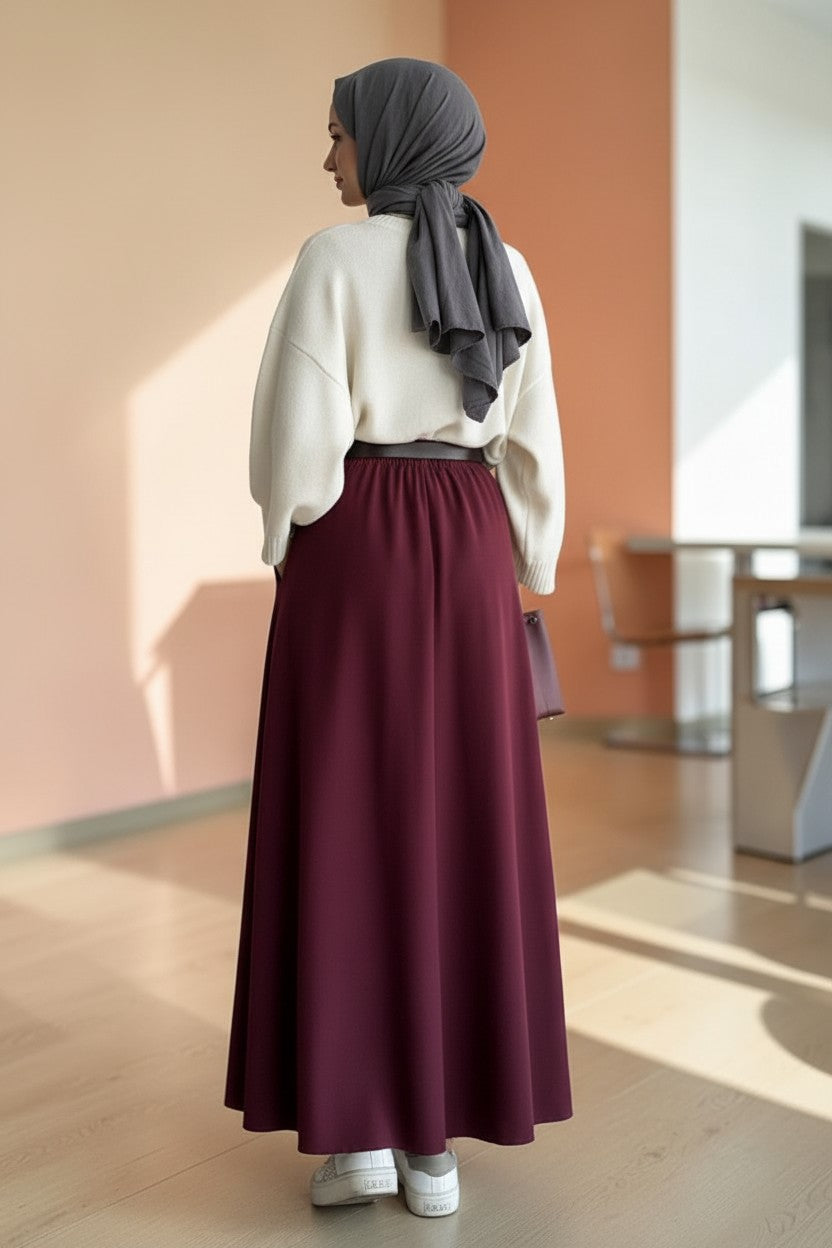 Cherianne.com burgundy flared maxi skirt in polyester poplin fabric with side pockets and a zipper closure.