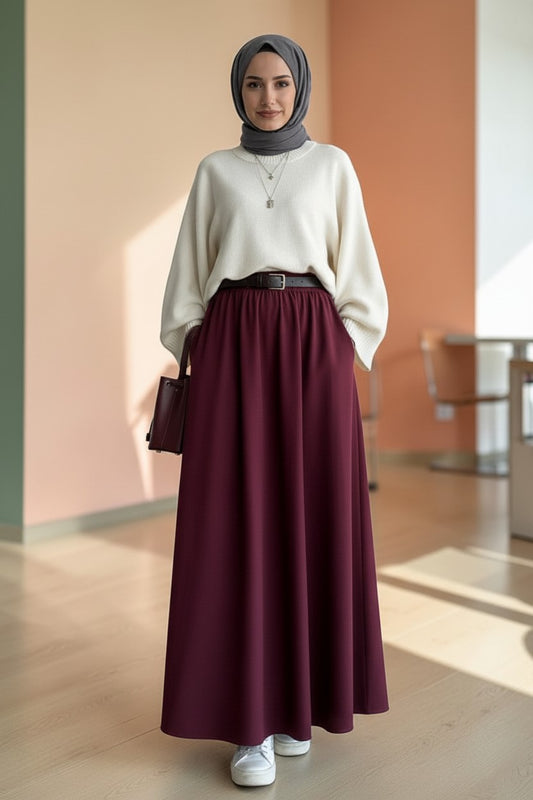 Cherianne.com burgundy poplin maxi skirt with a flared cut, styled with a white sweater and a dark gray hijab.