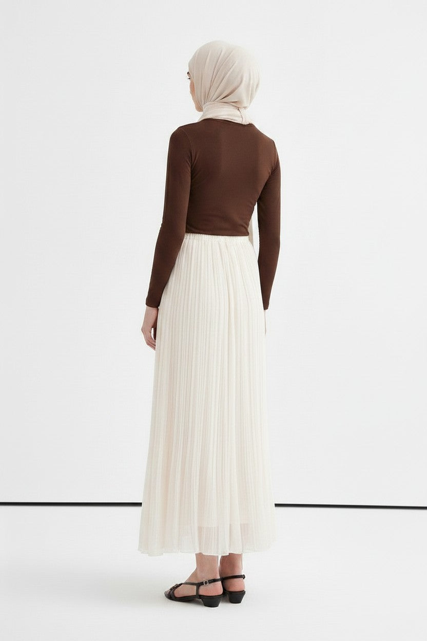 Cherianne.com ecru crush chiffon pleated maxi skirt worn with a brown long-sleeve top and headscarf, back view