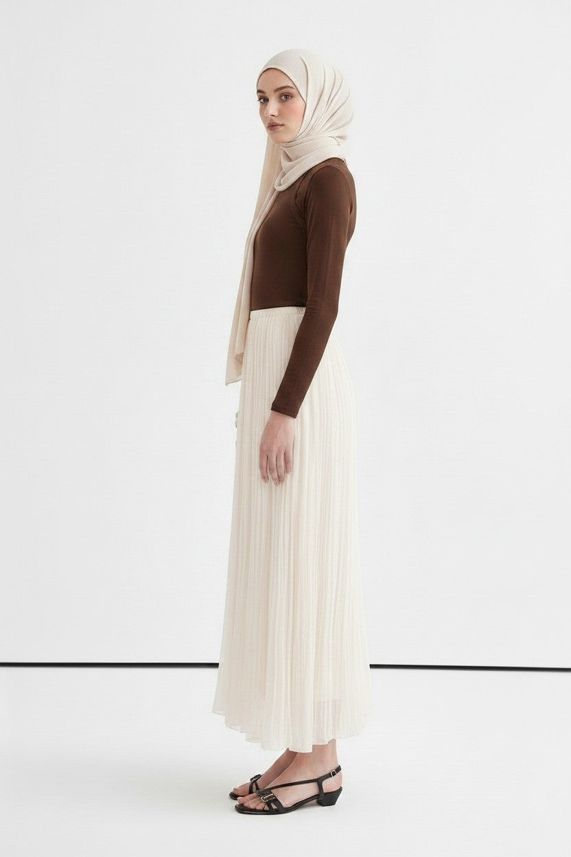 Cherianne.com ecru crush chiffon maxi skirt with an elastic waist, worn by a model with a matching hijab.