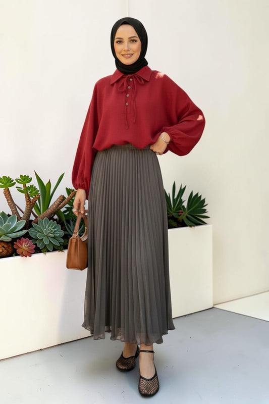 Cherianne.com gray pleated maxi chiffon skirt worn by a model with a red blouse and black hijab