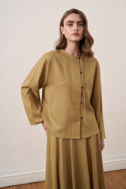 Cherianne.com mustard yellow linen shirt and matching long skirt worn by a model, back view