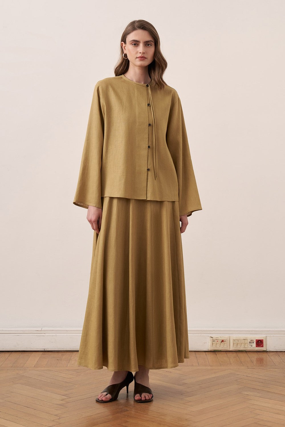 Cherianne.com mustard yellow linen shirt and matching long skirt worn by a model, back view