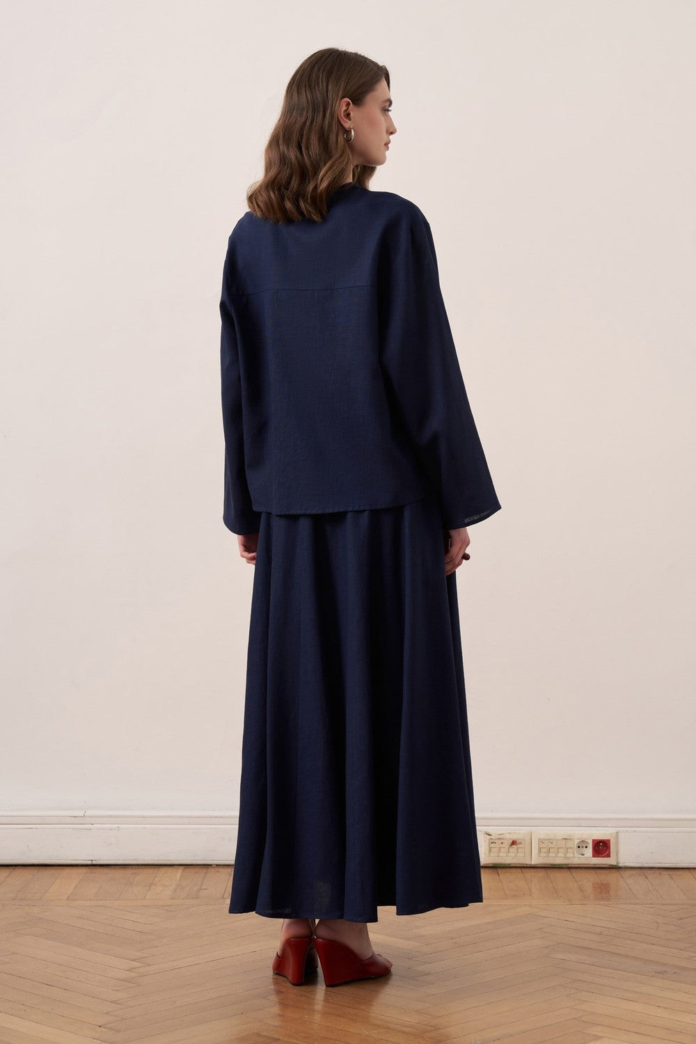 Cherianne.com navy blue linen blend shirt and matching maxi skirt worn by a model from the back view