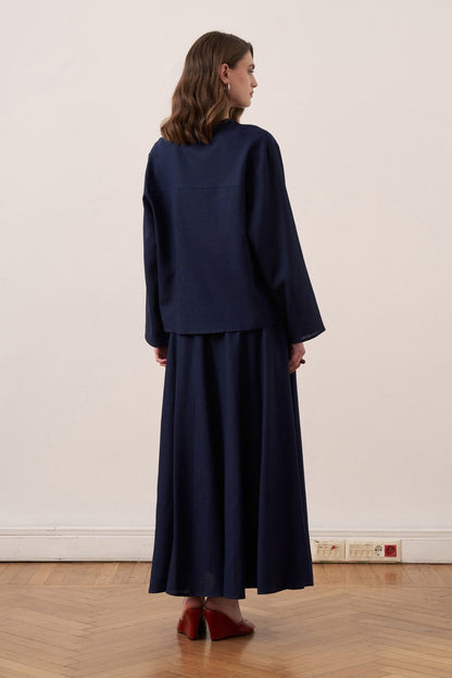 Cherianne.com navy blue linen blend shirt and matching maxi skirt worn by a model from the back view