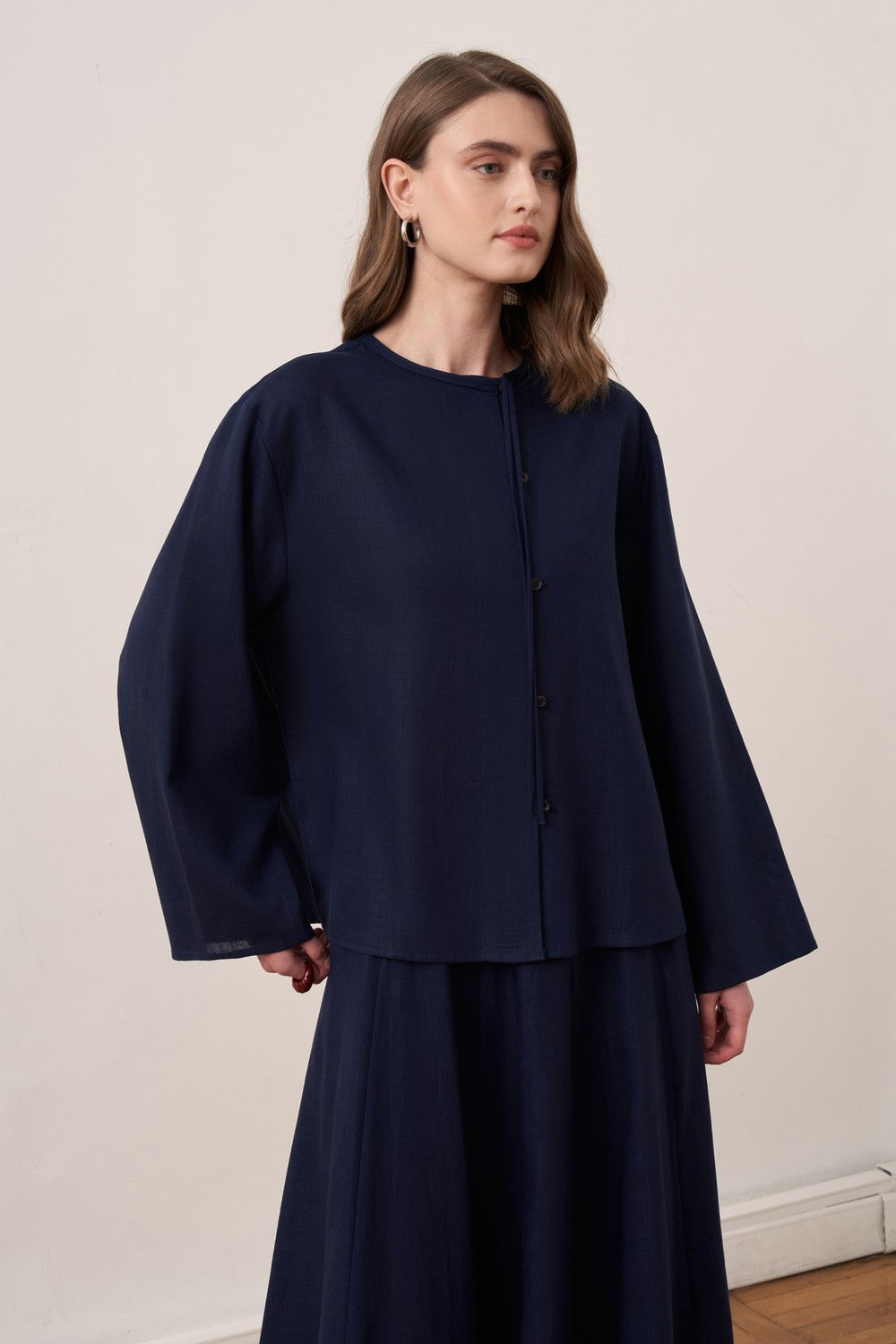 Cherianne.com navy blue linen blend shirt and matching maxi skirt worn by a model from the back view