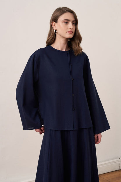Cherianne.com navy blue linen blend shirt and matching maxi skirt worn by a model from the back view