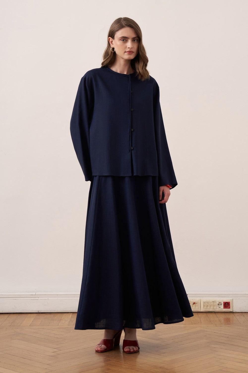 Model wearing a Cherianne.com navy blue linen blend shirt with mandarin collar and matching long skirt
