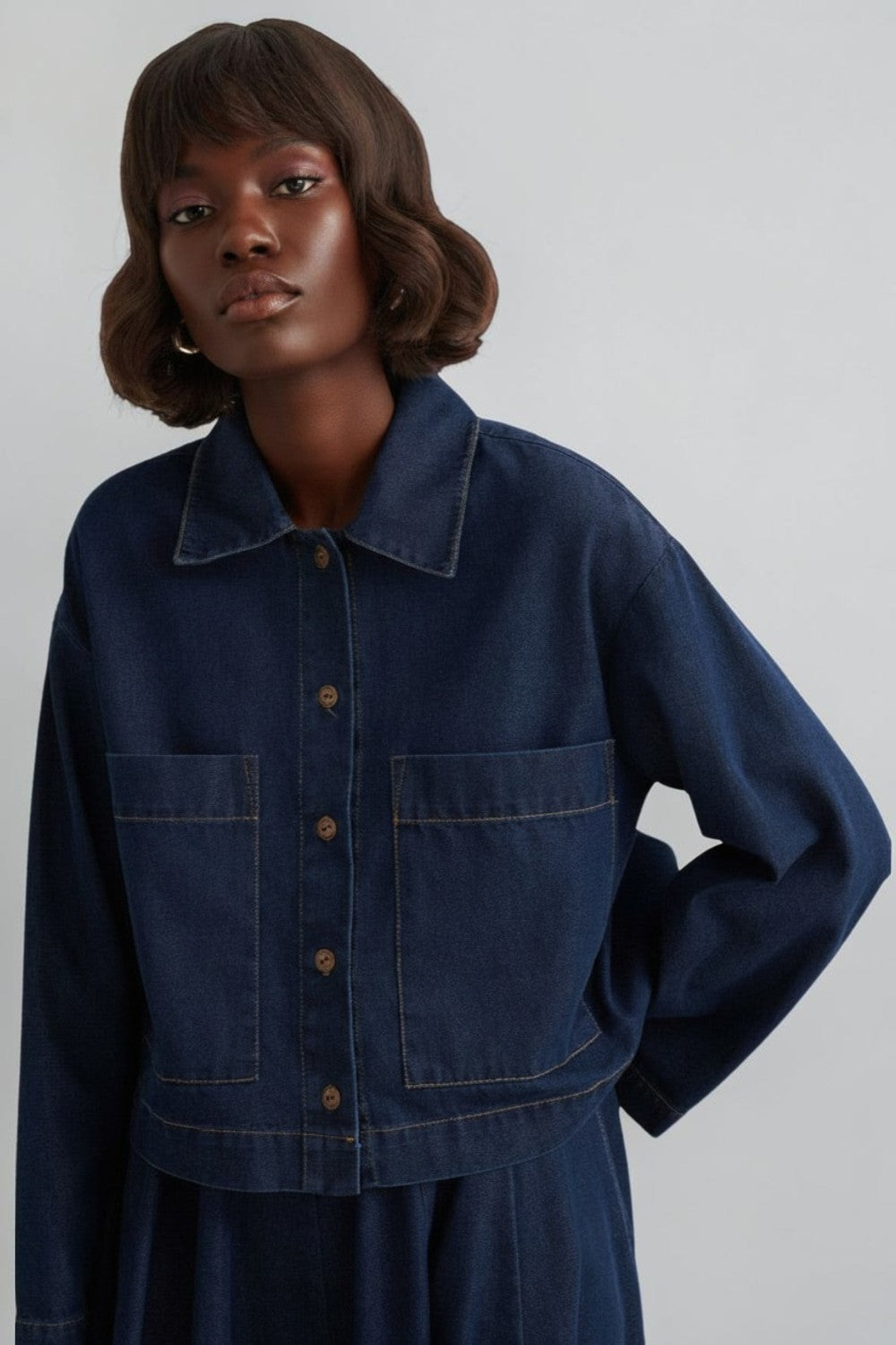 Cherianne.com navy blue denim shirt with a collar, button-down front, and large chest pockets on a model.
