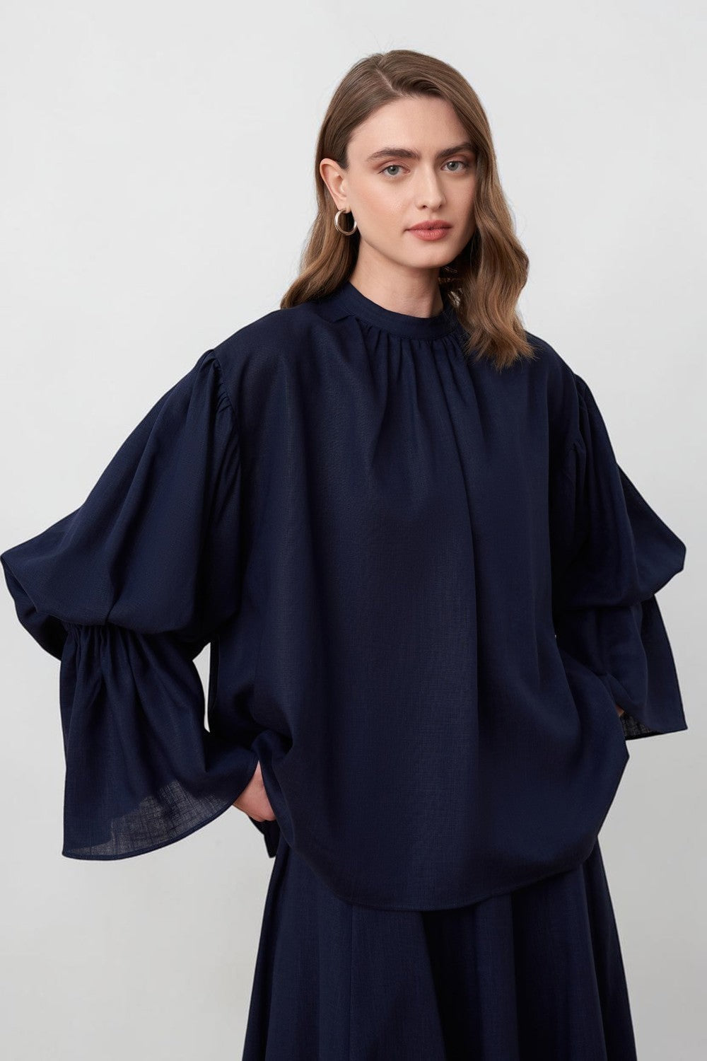 Cherianne.com navy blue linen blend blouse with voluminous balloon sleeves and a minimalist gathered mandarin collar.