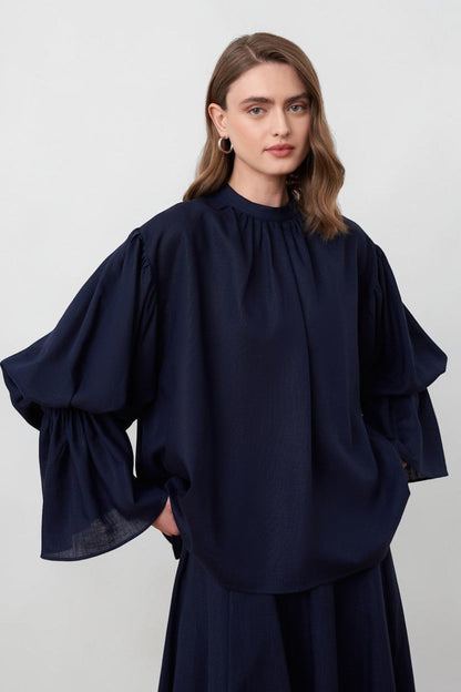 Cherianne.com navy blue linen blend blouse with voluminous balloon sleeves and a minimalist gathered mandarin collar.