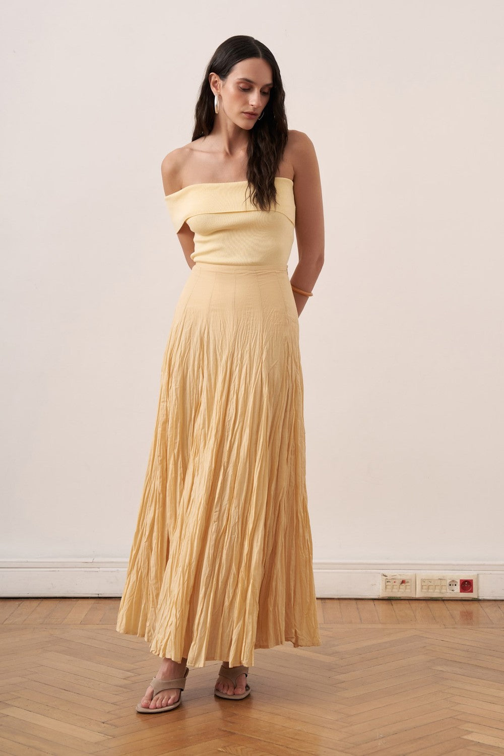 Cherianne.com yellow cotton voile maxi skirt with a crinkled texture and high-waisted paneled design on a model.