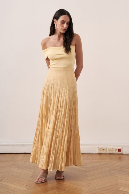 Cherianne.com yellow cotton voile maxi skirt with a crinkled texture and high-waisted paneled design on a model.