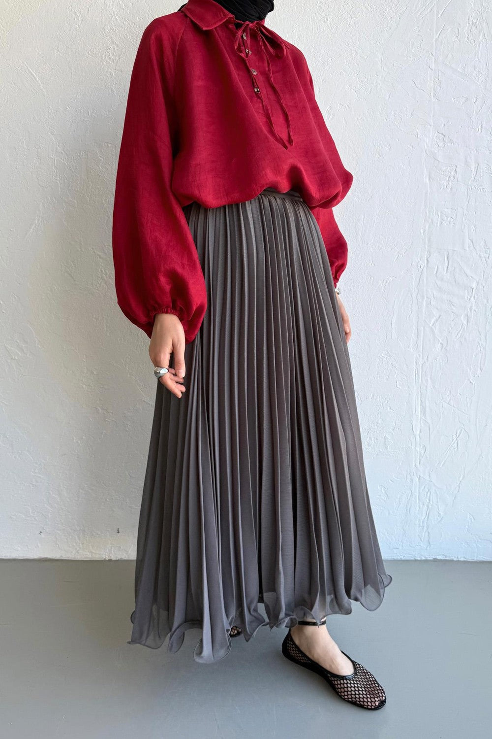 Cherianne.com gray pleated maxi skirt in chiffon fabric, styled with a long-sleeved red blouse.