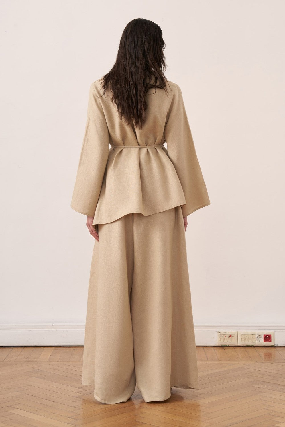 Cherianne.com wheat beige linen blouse with wide bell sleeves and a tie-waist, paired with matching wide-leg trousers.
